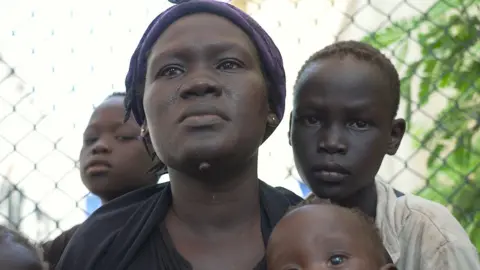 Hassan Lali/BBC Woman with her children