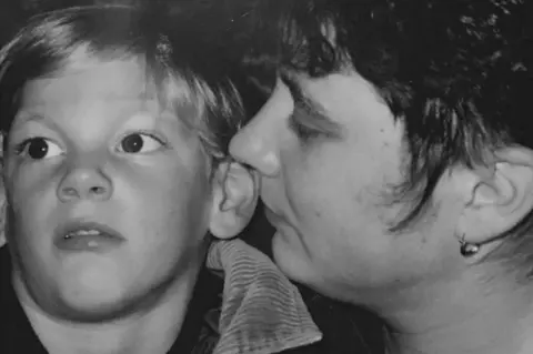 Family handout Martin Wells as a boy with his mum Chris in black and white