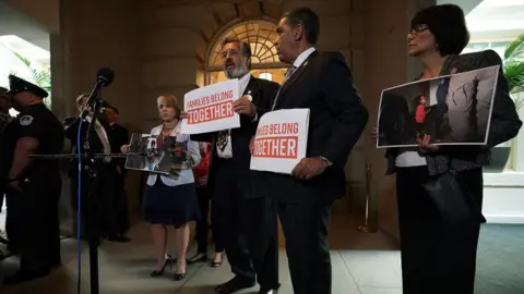 Getty Images California Congresswoman Lucille Roybal-Allard holds a photo of the image at a protest at Capitol Hill outside Mr Trump's meeting with Republicans on Tuesday