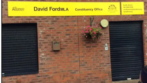 BBC The signs at Mr Ford's office include his phone number and email address