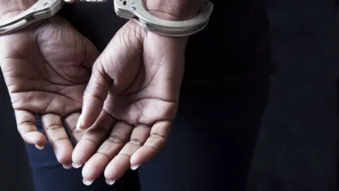 Getty Images woman in handcuffs