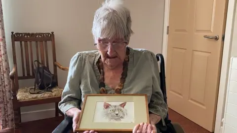 BBC Meriel Everett with her painting of a cat