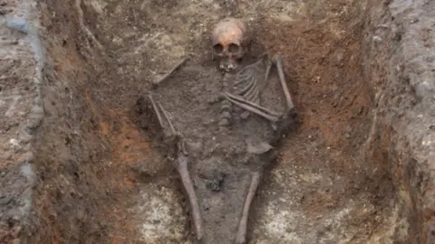 University of Cambridge/PA The skeleton of the girl, in her grave