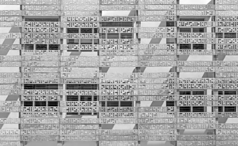 B.R.S.Sreenag / APA18 A building wall with metal panels with holes in