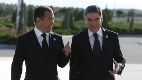 EPA Gurbanguly Berdymukhamedov and Dmitry Medvedev walking and talking