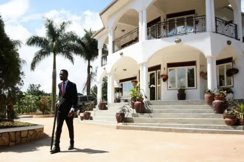 AFP Ugandan pop star turned opposition MP, Robert Kyagulanyi better known as Bobi Wine, walks with a cane to attend his media conference at his home in Kampala on September 24, 2018.