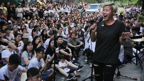 Getty Images Denise Ho performs during a free concert in Hong Kong in 2016 after cosmetics giant Lancome cancelled a concert featuring the local singer