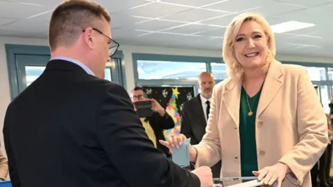 Getty Images French far-right party Rassemblement National (RN) presidential candidate Marine Le Pen casts her ballot for the first round of France's presidential election at a polling station in Henin-Beaumont