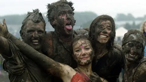 Getty Images Festival go-ers covered in mud