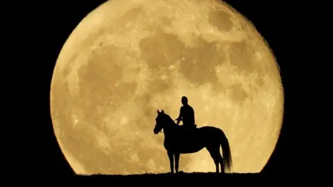 Jonay Ravelo and his horse Nivaria observe the super moon known as the blue Moon
