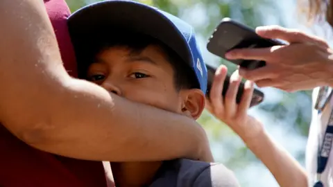 Mother and son embrace