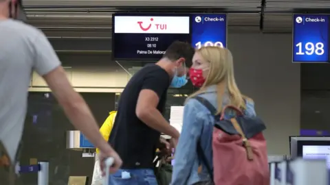 Getty Images People check in for a Tui flight from Dusseldorf to Mallorca in June