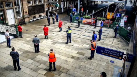 Getty Images Staff at Waverley Station in Edinburgh paused to mark the anniversary