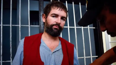 Getty Images Frenchman Felix Dorfin is escorted back to prison after he was sentenced to death by a court in Mataram