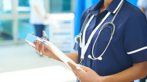 Getty Images A stock image of a nurse holding a clipboard