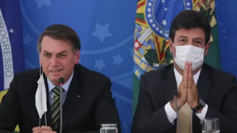 Getty Images President Bolsonaro and Mr Mandetta at a briefing