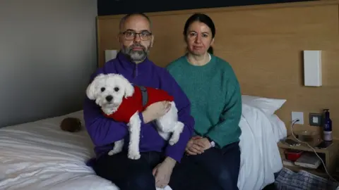 Facundo Arrizabalaga/LDRS Russel Harland and Selma Agirgol-Harland with their dog in the Travelodge London Chessington Tolworth