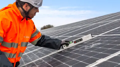 A man installing a solar roof