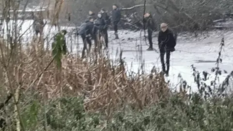 Simon English The Darlington pond with people on it