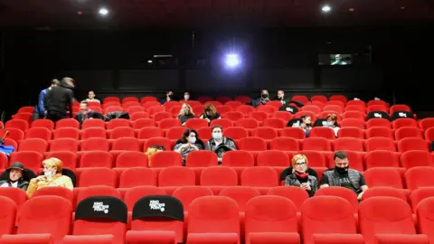 AFP People in protective masks at a cinema in Sarajevo