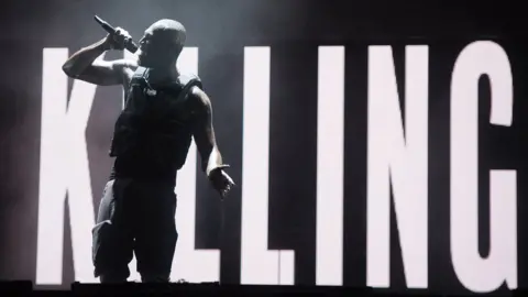 Getty Images Stormzy in front of a screen that reads "Killing"