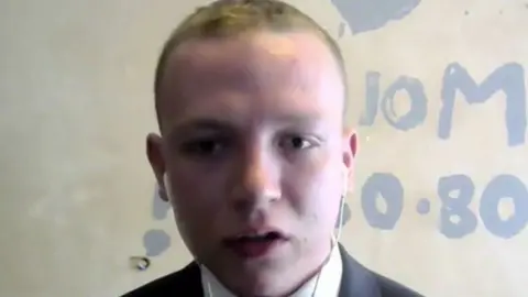 BBC Joel Keys appearing in shot on a web camera before the Northern Ireland Affairs Committee