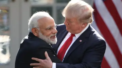 Getty Images President Donald Trump (R) and Indian Prime Minister Narendra Modi embrace outside the White House in 2017.