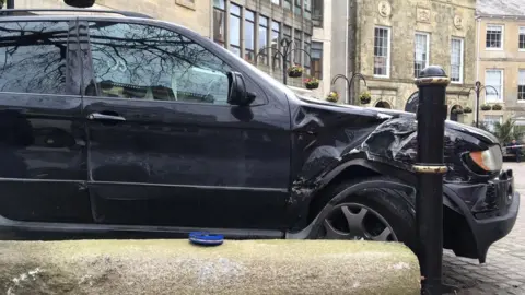 A car that has crashed into a bollard