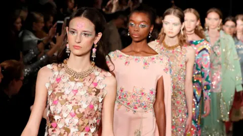 Gonzalo Fuentes/ Reuters A row of models on the catwalk.