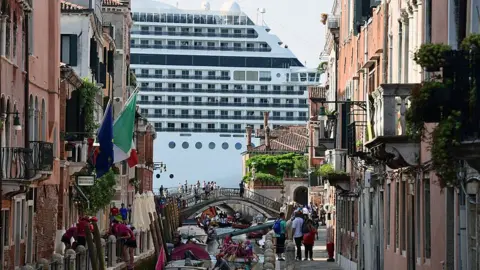 Getty Images Cruise ship MSC Magnifica is seen from one of the canals leading into the Venice Lagoon on 9 June 2019 in Venice.