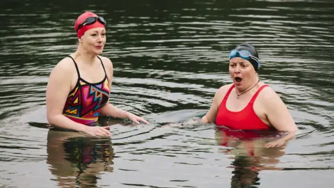 Getty Images two women swimming in cold water