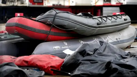PA Media Small boats stacked in a yard