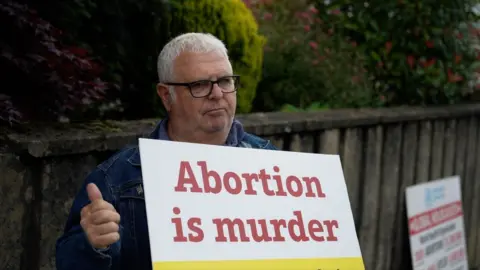 BBC Man holding anti-abortion placard