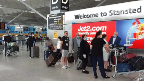 PA Media Travellers at Stansted Airport