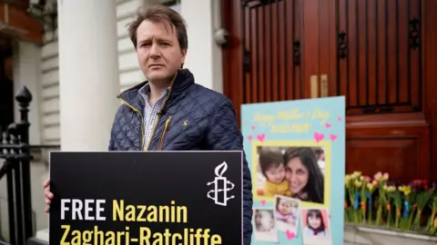 Reuters  Mr Ratcliffe holds a poster which reads "Free Nazanin"