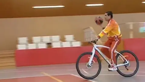 Altyn Asyr Kurbanguly Berdymukhamedov playing basketball on a bicycle