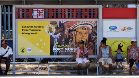 Getty Images This picture taken on November 13, 2018 shows residents waiting at a bus stop donated by China in downtown Port Moresby, ahead of the Asia-Pacific Economic Cooperation (APEC) summi