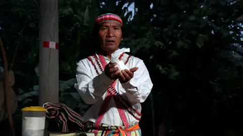 Reuters Shainkiam Yampik Wananch, a deacon ordained by the Catholic Church, holds up a host during a liturgy with indigenous Achuar people at a chapel in Wijint, a village in the Peruvian Amazon, Peru August 20, 2019.