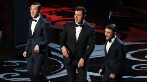 Getty Images Joseph Gordon-Levitt, Seth MacFarlane and Daniel Radcliffe sing on stage at the Oscars