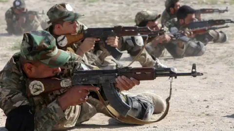 Reuters Members of Iraq's paramilitary Popular Mobilisation force take part in weapons training in Basra (4 August 2019)