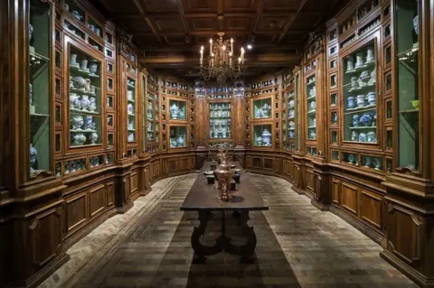 Guillaume Souvant / Getty Images A room with many draws and cabinets containing bottles