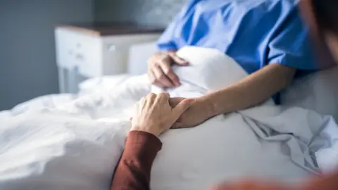 Getty Images Holding hand of patient