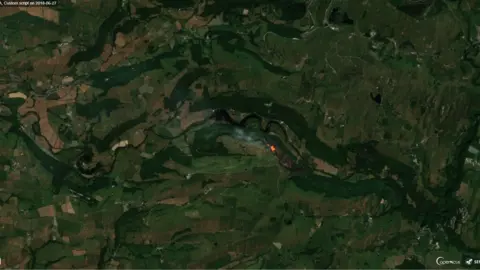 Contains modified Copernicus Sentinel data [2018] A satellite image of the fire in Cwm Rheidol on Wednesday around midday when the satellite passed over the area. The grey area is the ‘burn scar’ and the orange is the still burning fire.