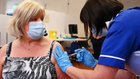 Getty Images Woman getting a booster jab