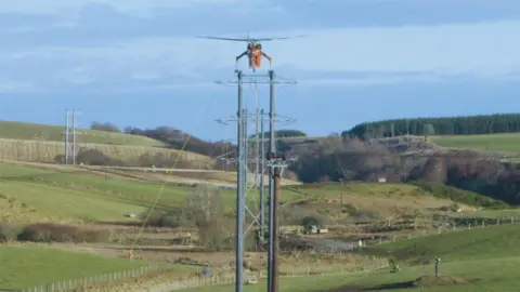 SSE/BALFOUR BEATTY Helicopter and electricity towers