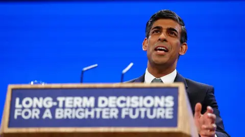 Reuters An image showing Prime Minister Rishi Sunak addressing the Conservative Party Conference in Manchester