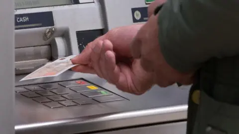 PA Media Person using cash machine