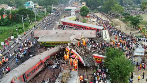 Reuters Rescuers at scene of deadly train crash