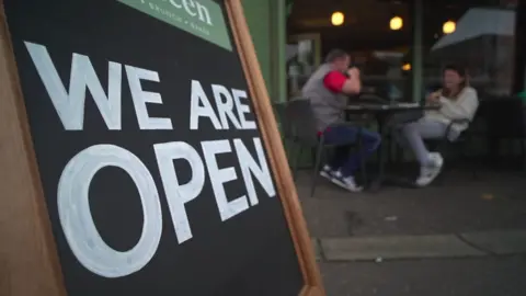 A sign outside a cafe - it reads: We are open