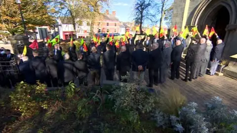 Flags held as guard of honour at William "Harry" Hardy's funeral